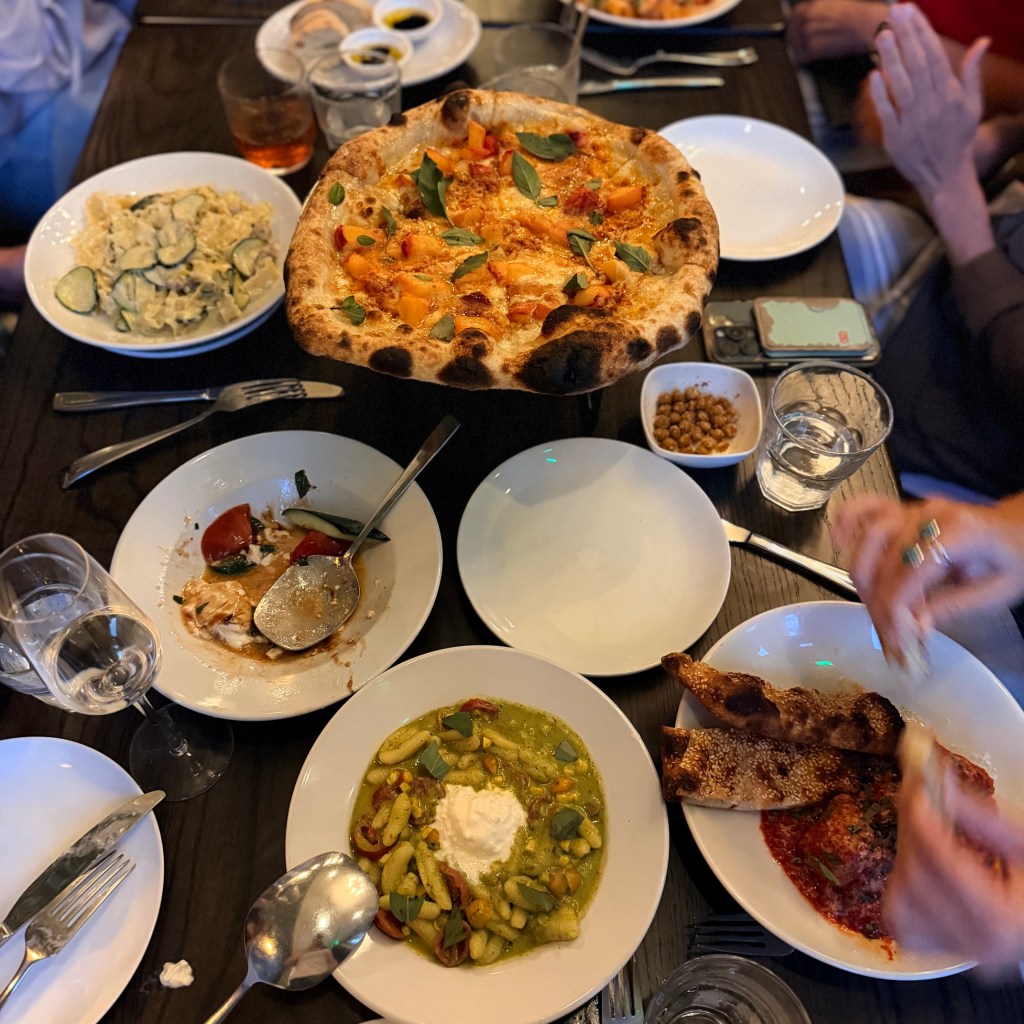 Pizza, pasta and cucumber salad.
